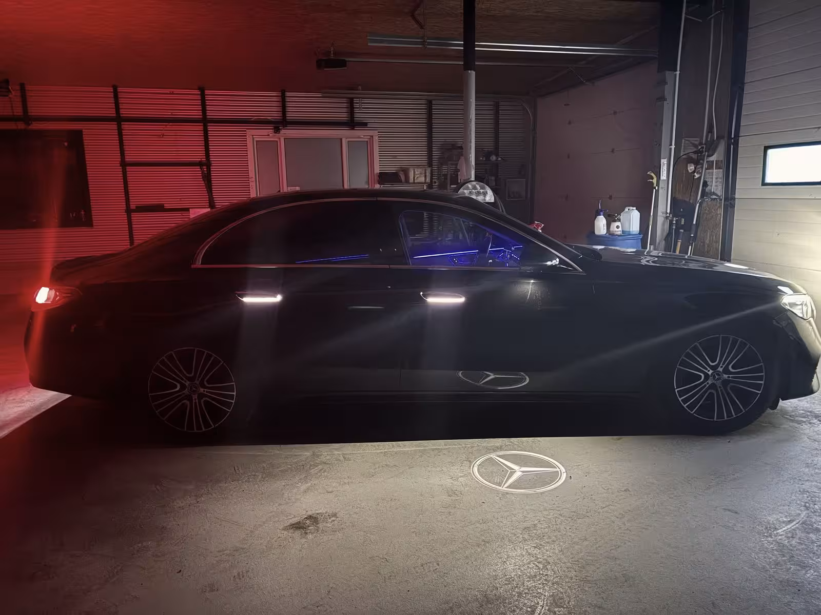 Sleek black Mercedes luxury sedan with iconic star logo projection for private airport transfer from Reykjavik to Keflavik