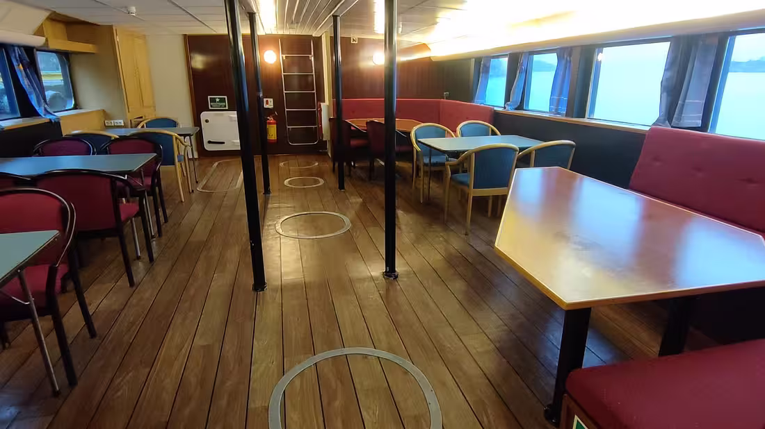Inside of a boat used to spot Northern Lights, with a comfortable seating area inside