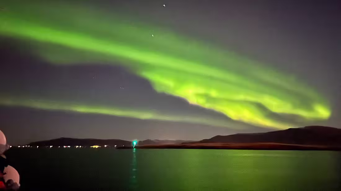Northern Lights in the night's sky above the ocean