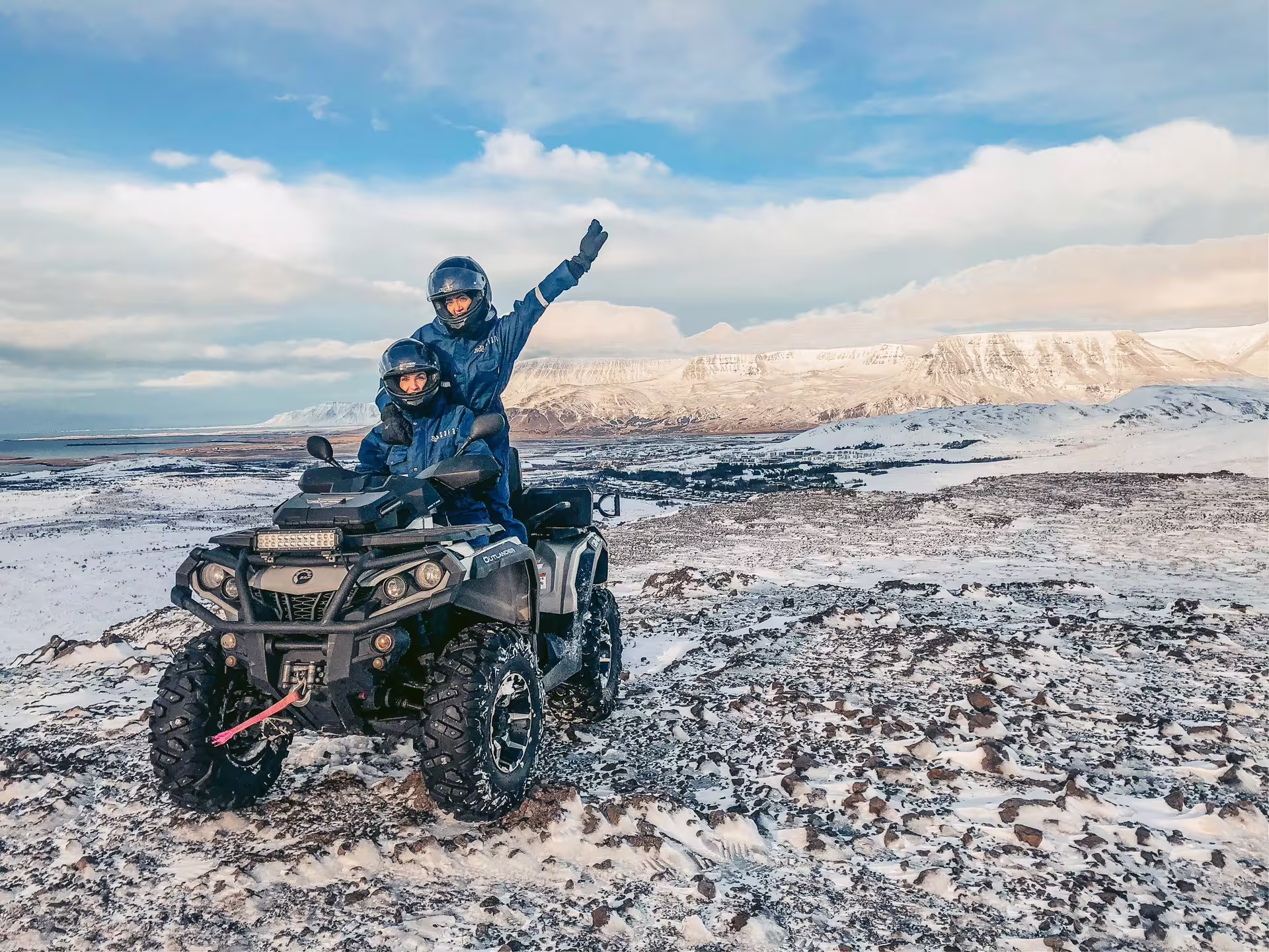 Two people on an ATV explore snowy Reykjavik peaks, capturing adventure and scenic views on a thrilling 1-hour tour.