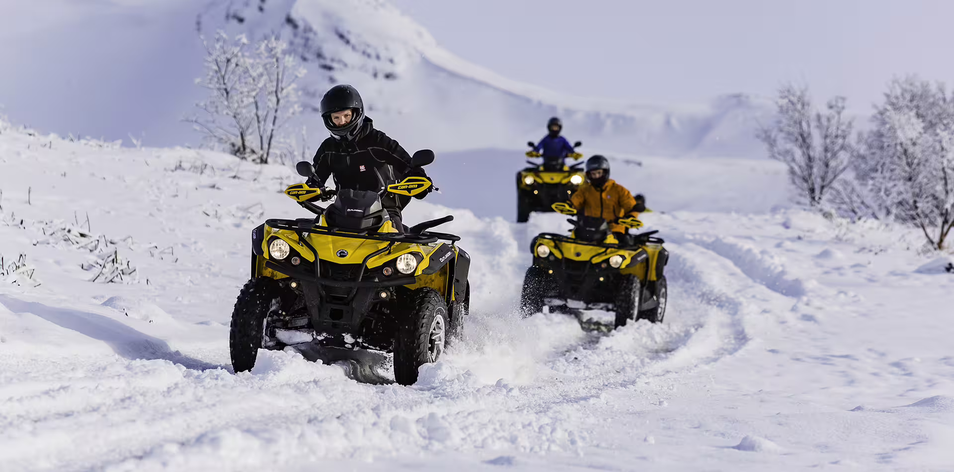Adventurers ride ATVs through snowy landscapes during the 1 Hour Reykjavik Peak ATV tour, showcasing Iceland’s winter beauty.