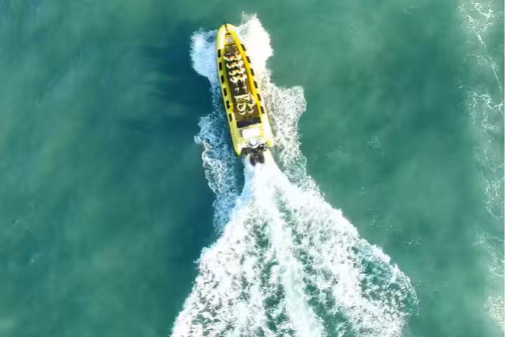 Aerial view of yellow RIB speedboat cutting through turquoise waters near Reykjavik