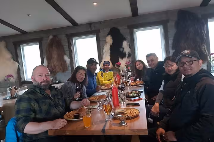 Group of tourists dining together at a rustic restaurant during a Reykjavik food and culture tour