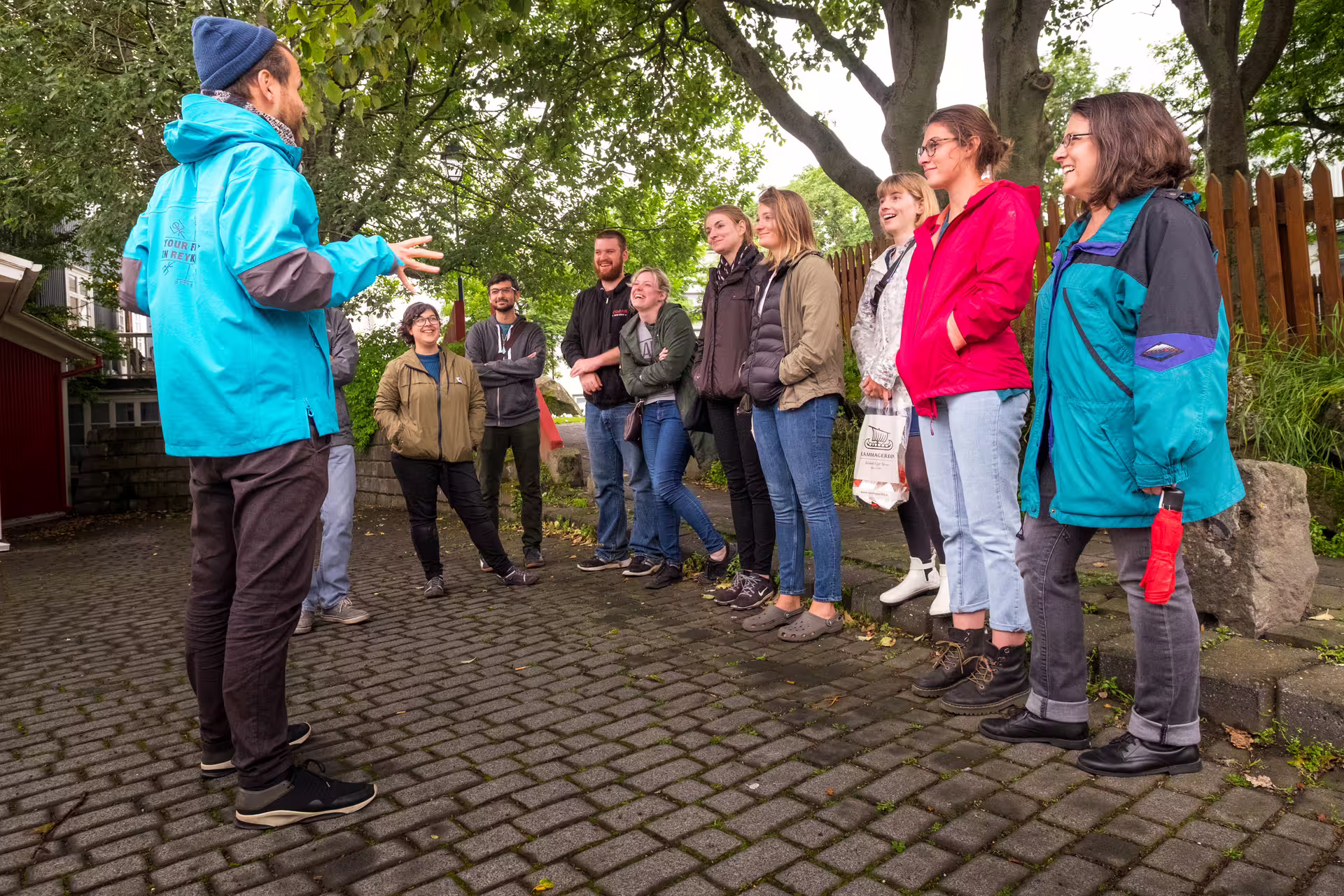 Tour guide in blue jacket leading a small group on a walking tour in Reykjavik
