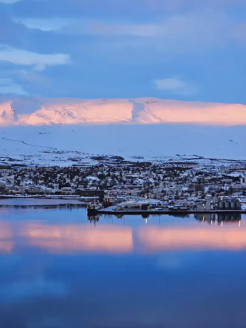 Reykjavik winter skyline reflected on calm water, Iceland Christmas dreams private tour getaway and wellness vibe