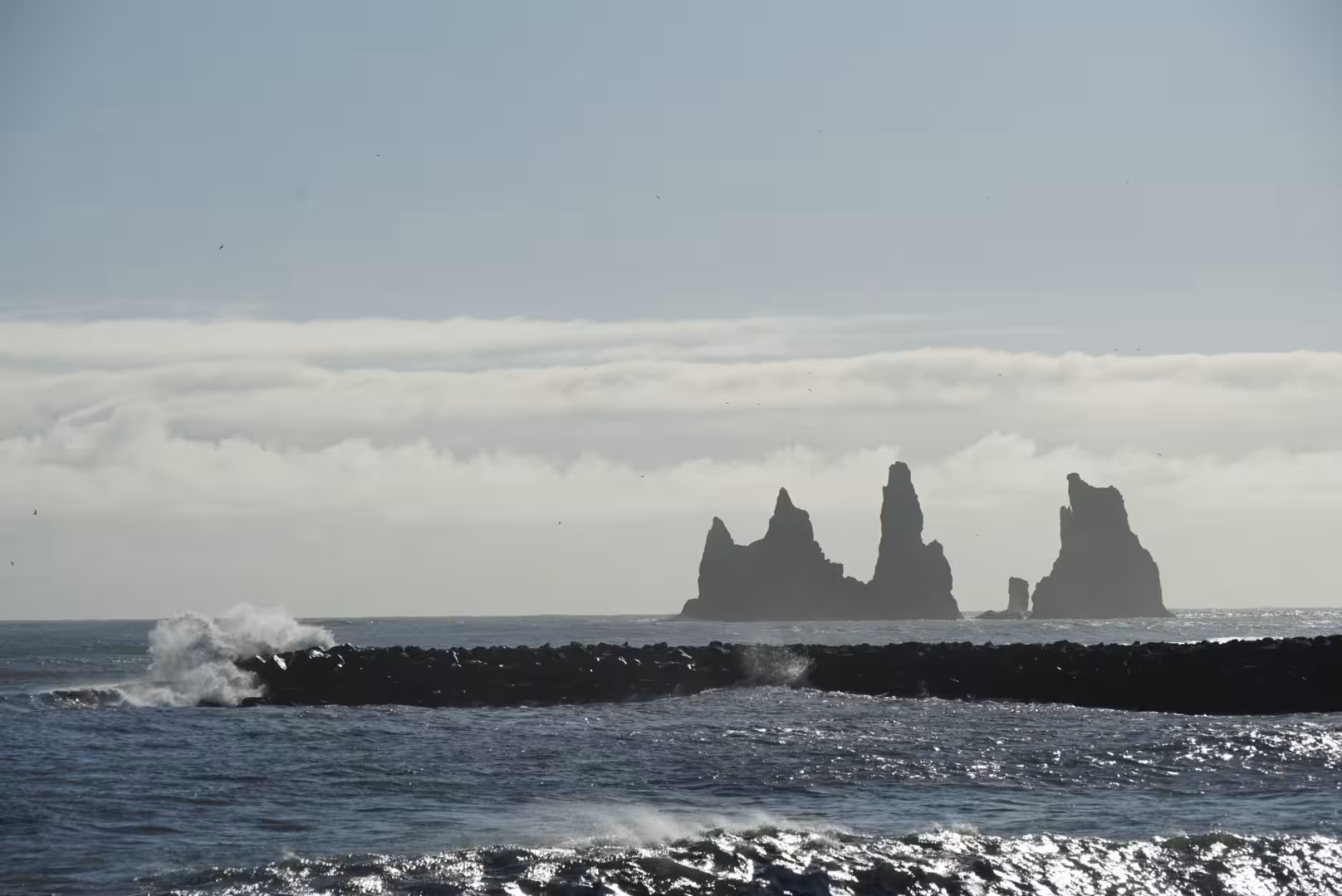 Reynisdrangar basalt sea stacks rising from the Atlantic Ocean on Iceland's South Coast