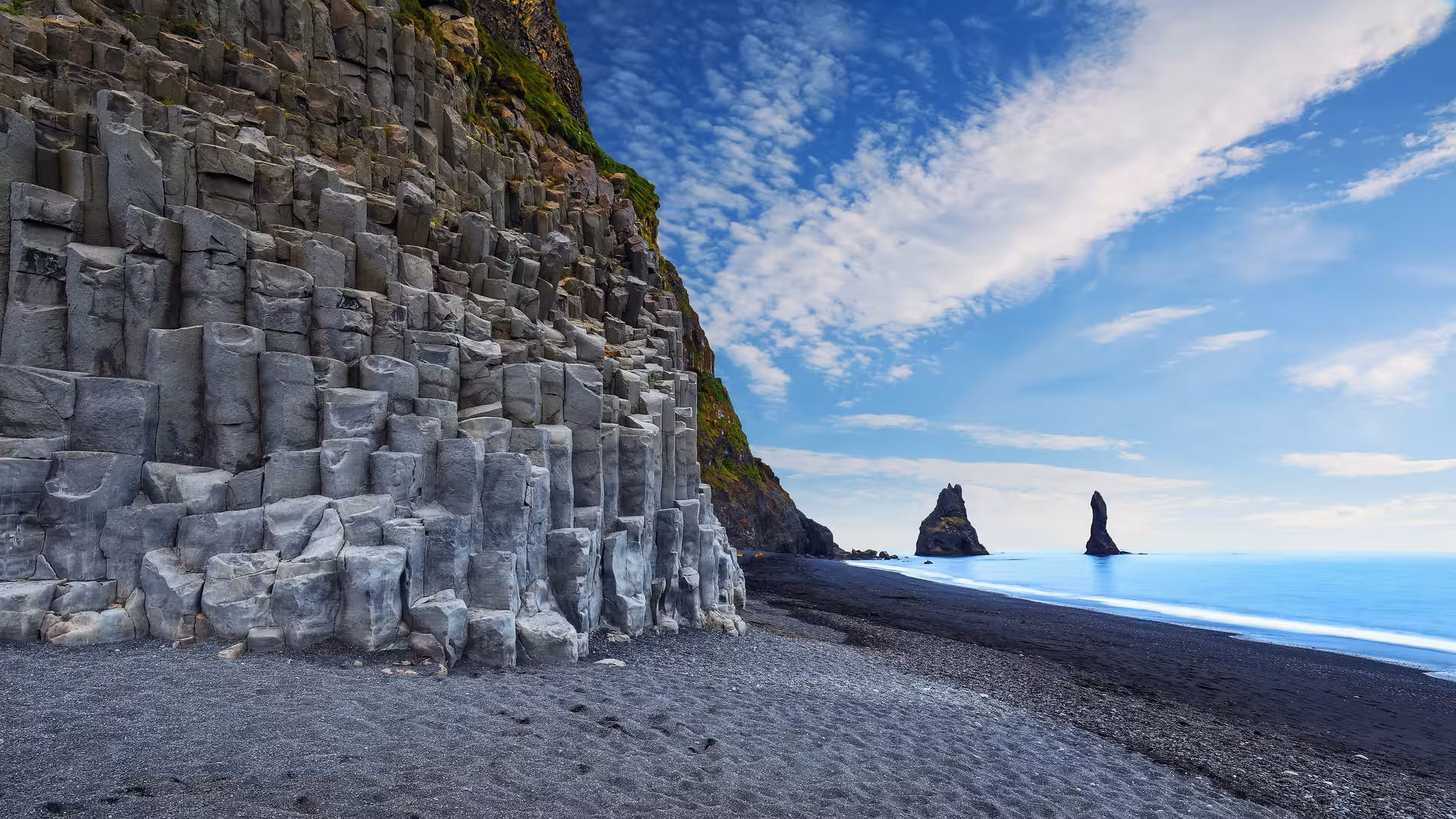 Stunning basalt columns and Reynisdrangar sea stacks at Reynisfjara Beach on the 5-day Iceland tour.