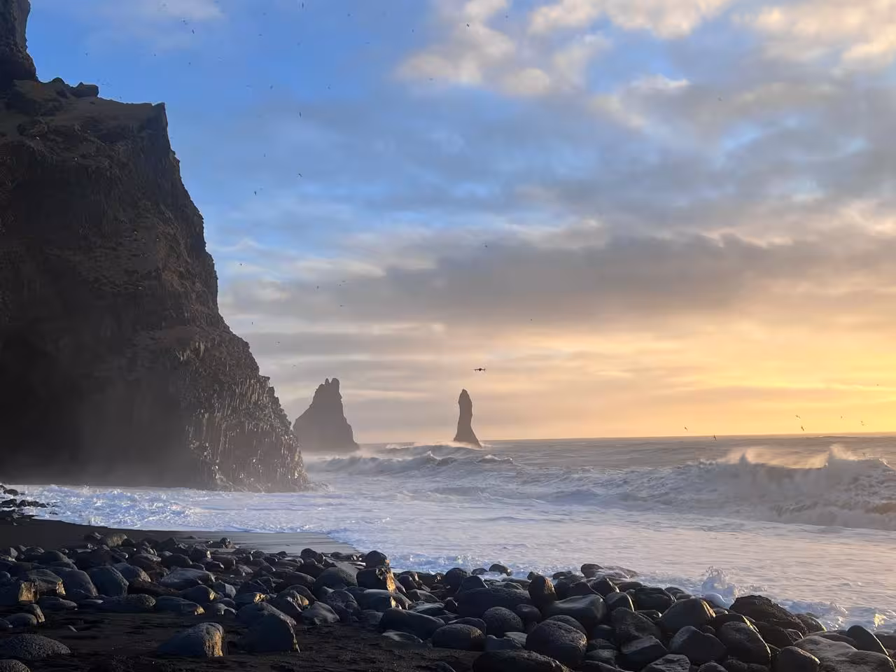 Reynisfjara black sand beach and Reynisdrangar sea stacks at sunset on South Coast private tour from Reykjavik