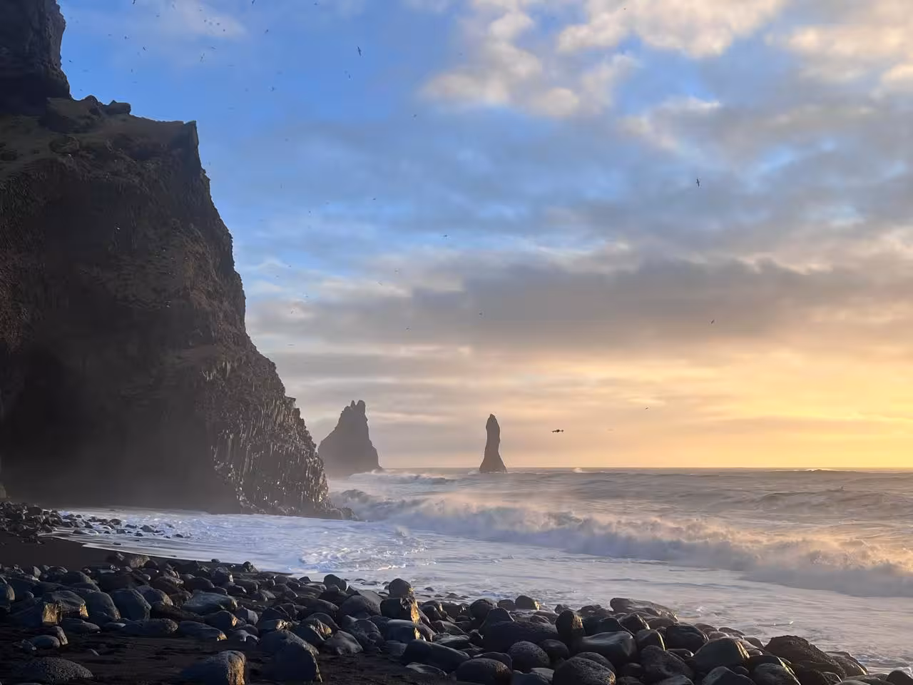 Reynisfjara black sand beach at sunset with Reynisdrangar sea stacks on South Coast private tour