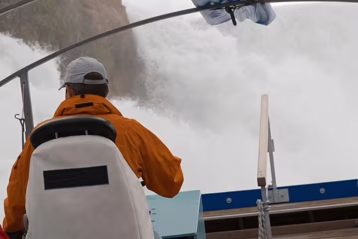 Boat approaching the majestic Rhine Falls on a Zurich private day trip, offering thrilling close-up views.