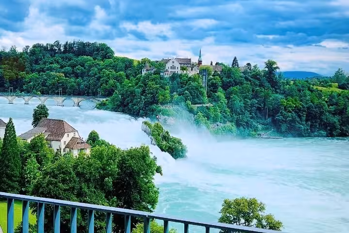 Panoramic Rhine Falls waterfall and river with lush greenery, Switzerland, on a half-day luxury sightseeing tour