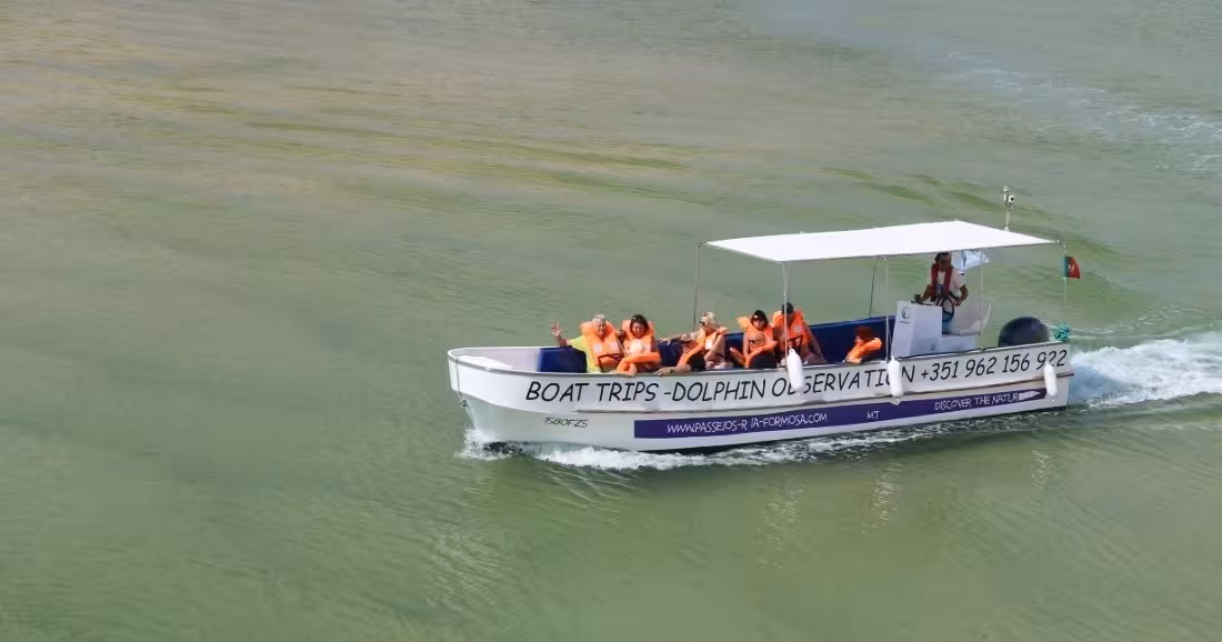 Tourists in orange life jackets enjoying a 2-hour boat tour in Ria Formosa Natural Park Algarve Portugal