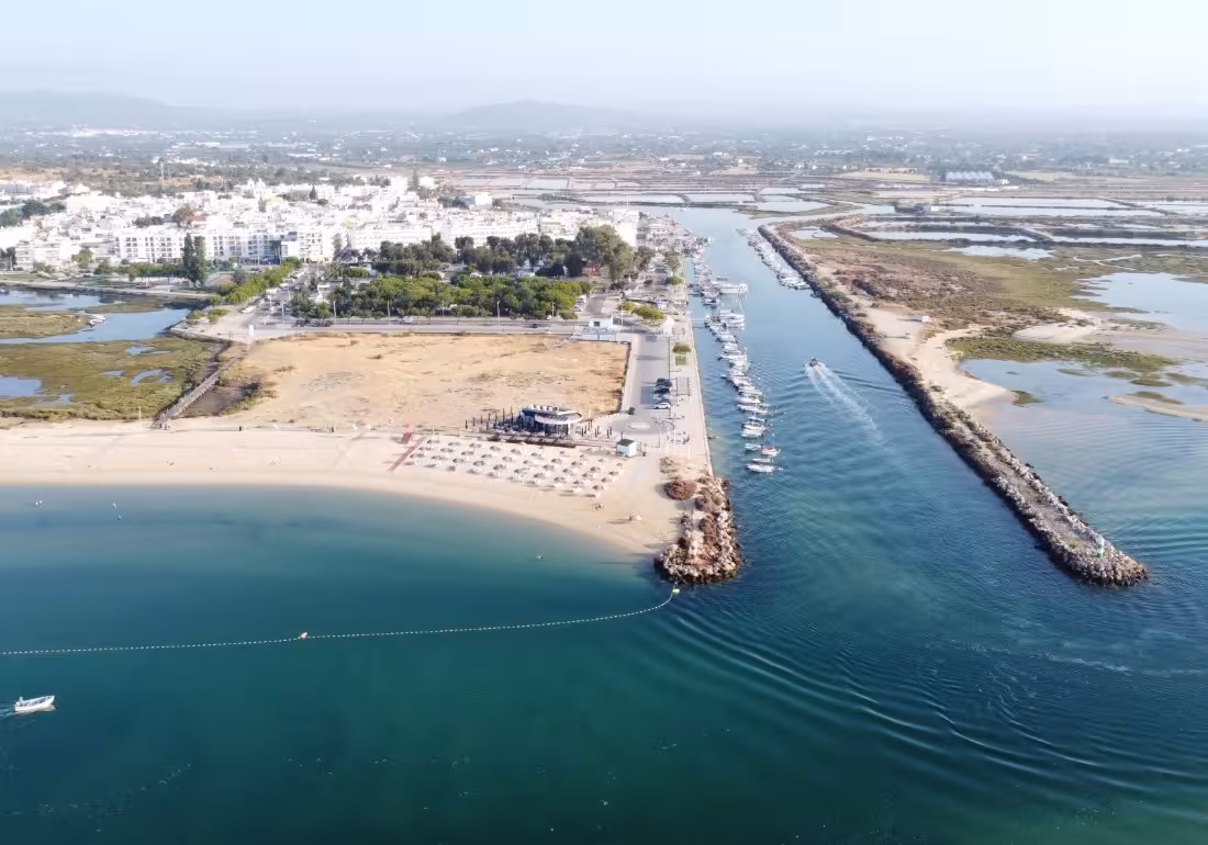 Aerial view of Ria Formosa lagoon marina and Algarve coastline perfect for boat tours to Armona Island
