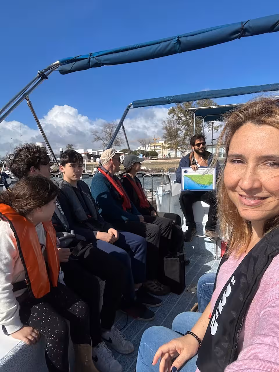 Guests seated on a Ria Formosa boat tour as the guide briefs the 3-island full-day itinerary from Faro marina