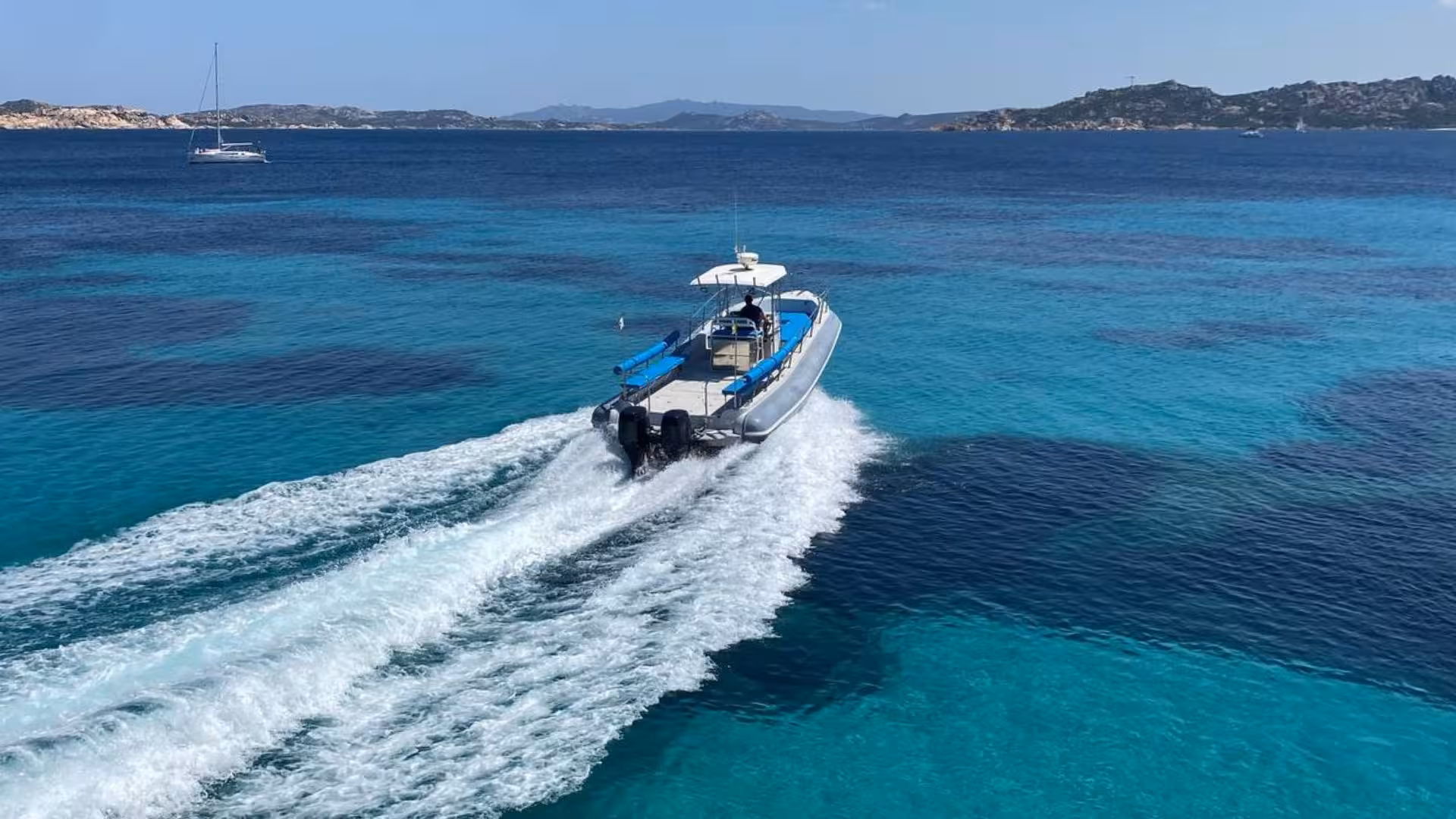 Speeding RIB boat on crystal-clear waters near Santa Teresa di Gallura during a private tour.