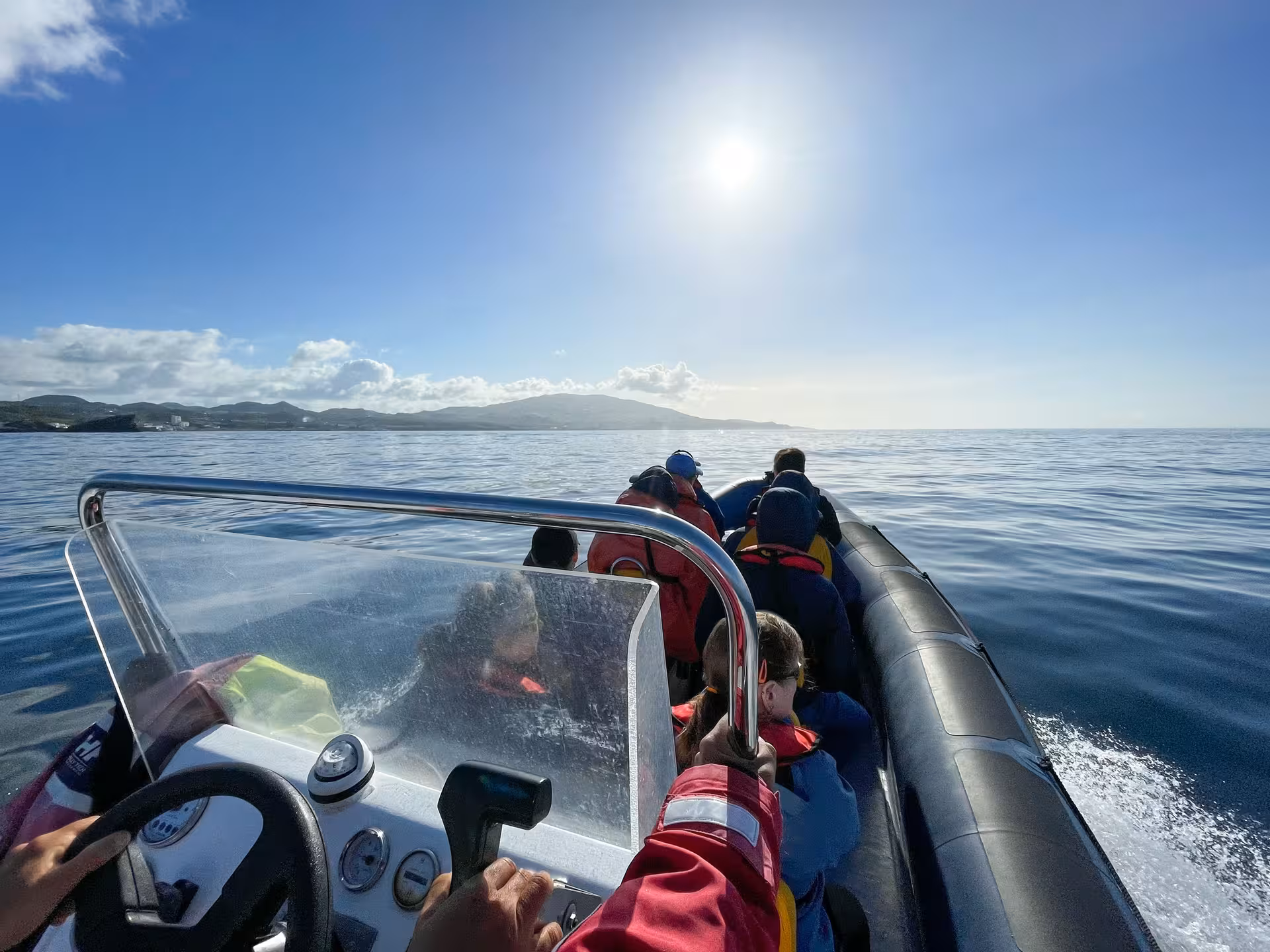 Passengers on RIB speedboat cruising coastal waters on full-day Maritime Experience tour with lunch and sea views