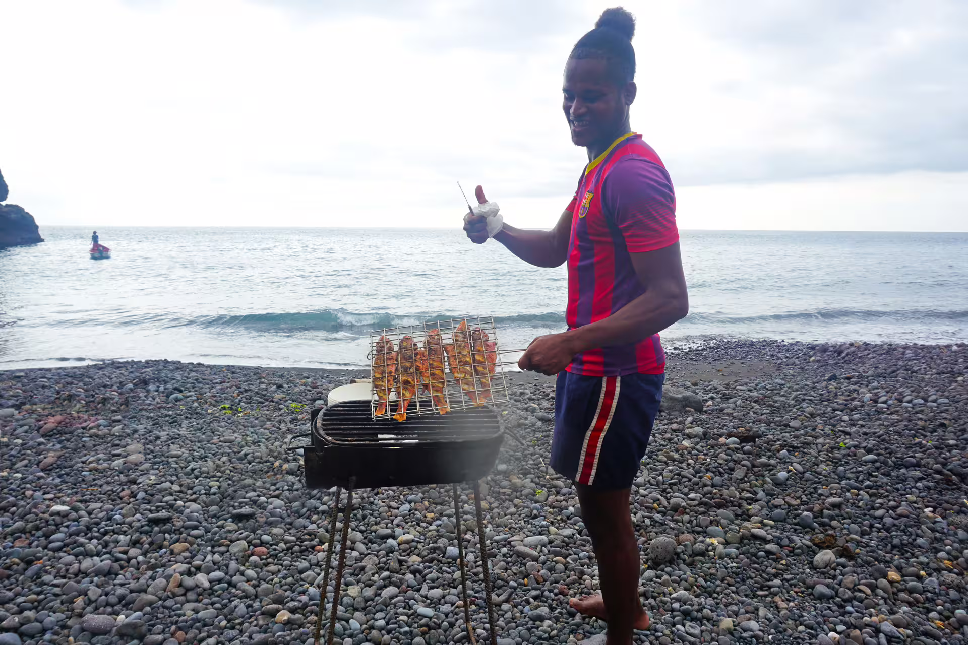 Beach BBQ grilling fresh fish on Ribeira da Barca boat tour after cave visit and snorkeling in Cape Verde