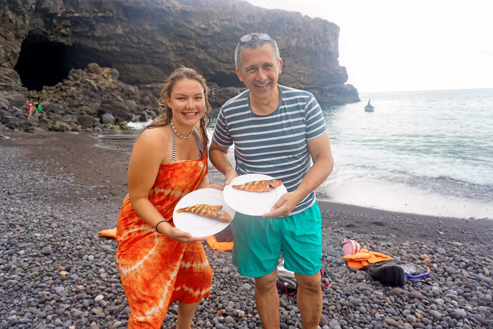 Guests enjoy beach BBQ fish after Ribeira da Barca boat trip to sea cave and snorkeling in Cape Verde
