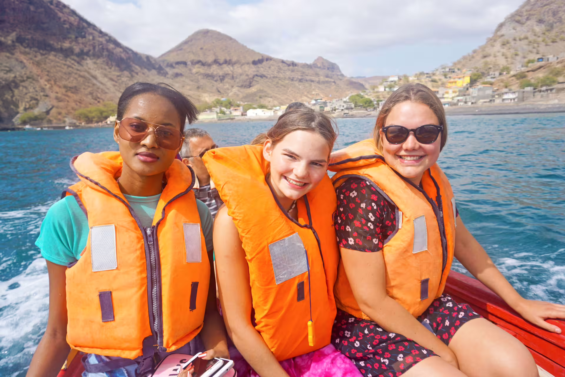 Smiling guests in life jackets on Ribeira da Barca boat tour, Cape Verde, heading to sea cave, snorkeling and BBQ