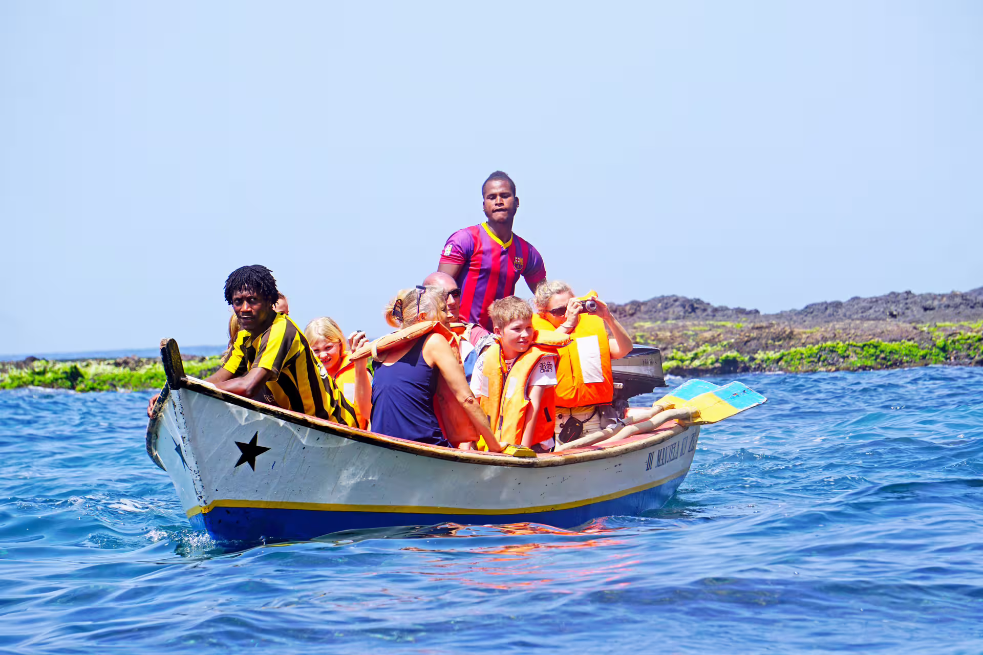 Guests in life jackets on Ribeira da Barca boat trip to sea cave, with snorkeling gear for beach BBQ stop