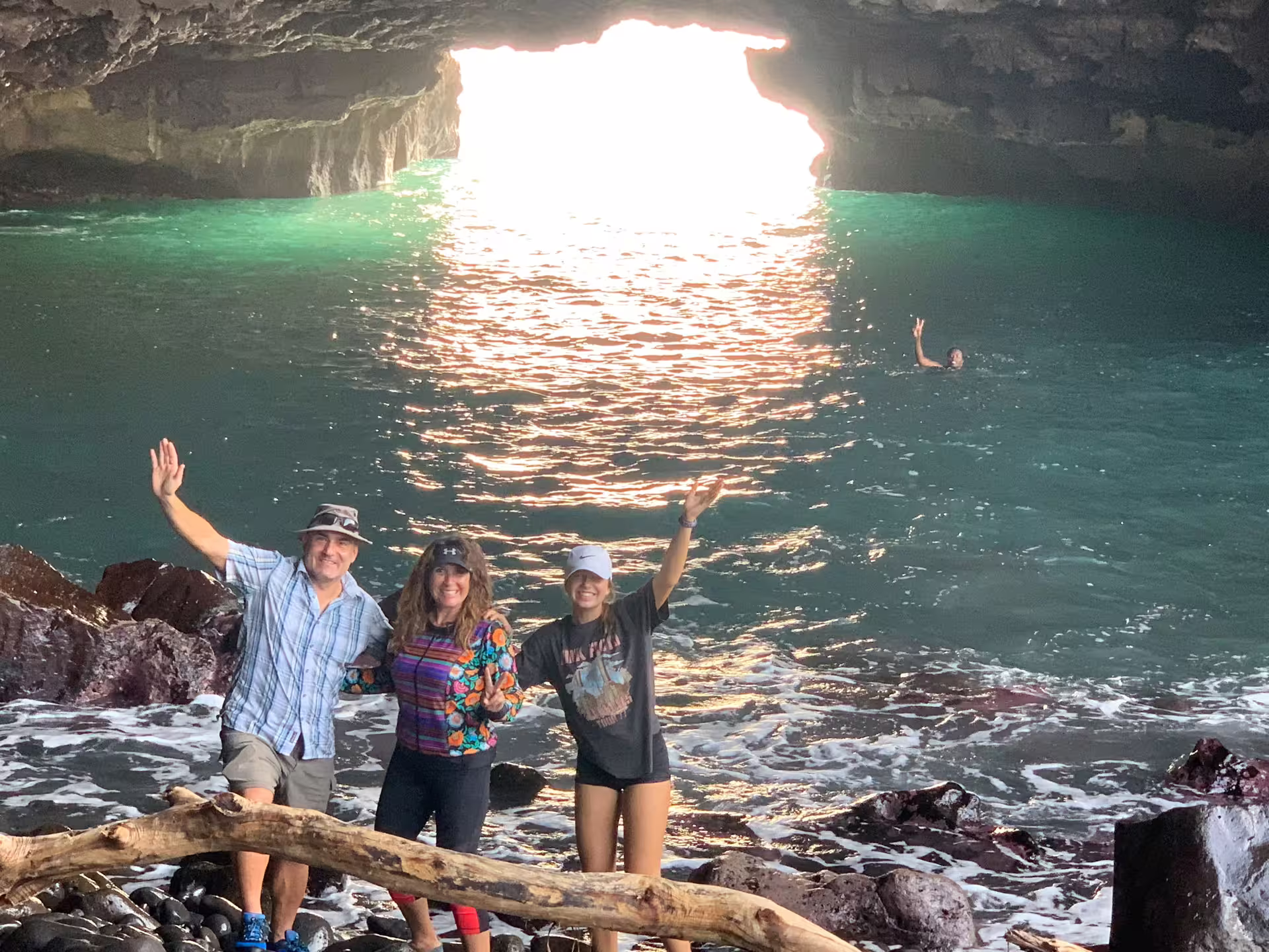 Guests waving inside Ribeira da Barca sea cave after boat trip, with turquoise water and snorkeling stop