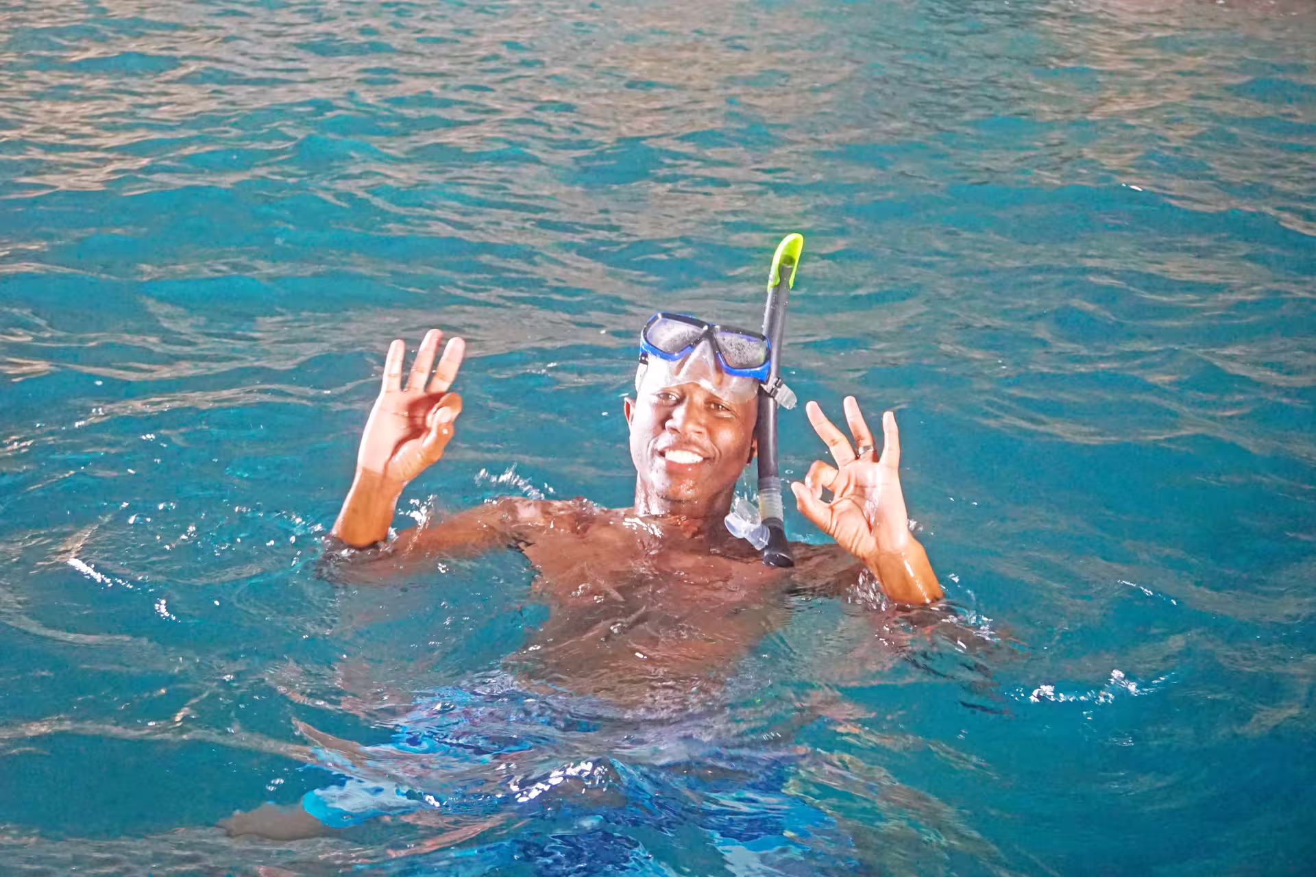Snorkeler in clear Atlantic water on Ribeira da Barca boat trip, ready for cave tour and beach BBQ