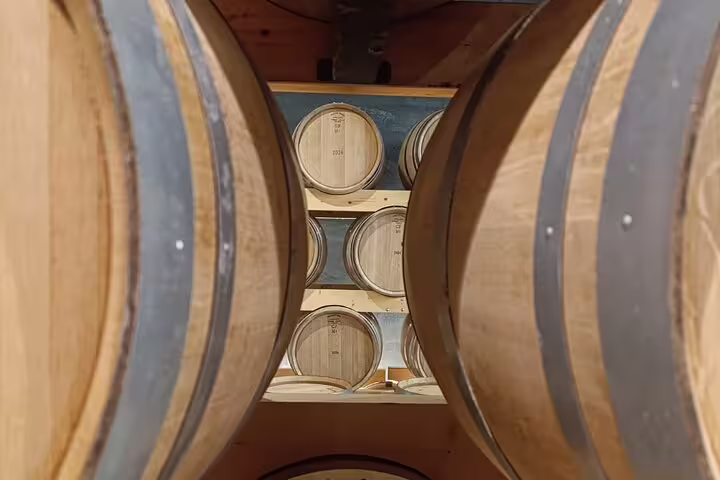 Close-up of oak barrels in a Ribera del Duero winery, highlighting the aging process on a Madrid tour.