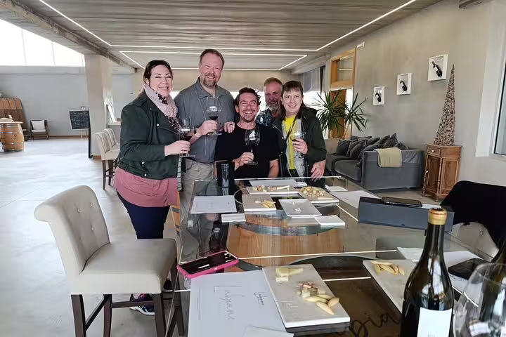 Visitors enjoying wine tasting experience in a modern Ribera del Duero winery.