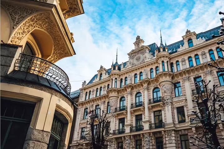 Ornate Art Nouveau facades in Riga with decorative balconies and sculptural details under blue sky