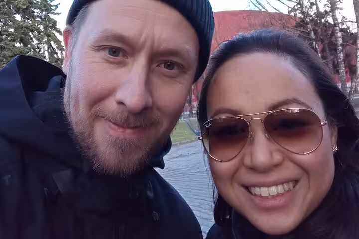 Couple smiling outdoors during Riga Art Nouveau walking tour on a cloudy day