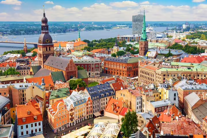 Aerial view of Riga Old Town with colorful Art Nouveau buildings, cathedral spires, and Daugava River