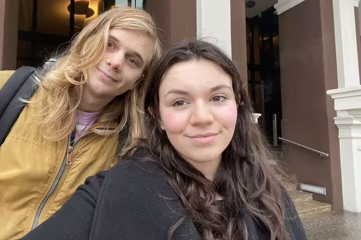 Two young tourists taking a selfie during a self-guided walking tour in Riga