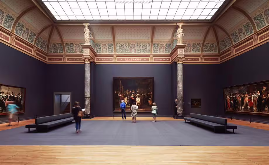Visitors admire Rembrandt's masterpieces in the grand gallery of the Rijksmuseum during a guided tour in Amsterdam.