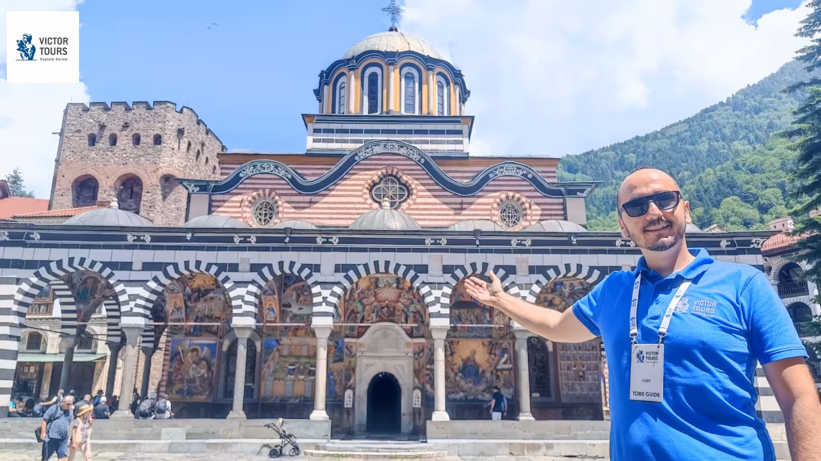 Tour guide presents iconic Rila Monastery with its ornate architecture and vibrant frescoes, Bulgaria cultural experience.
