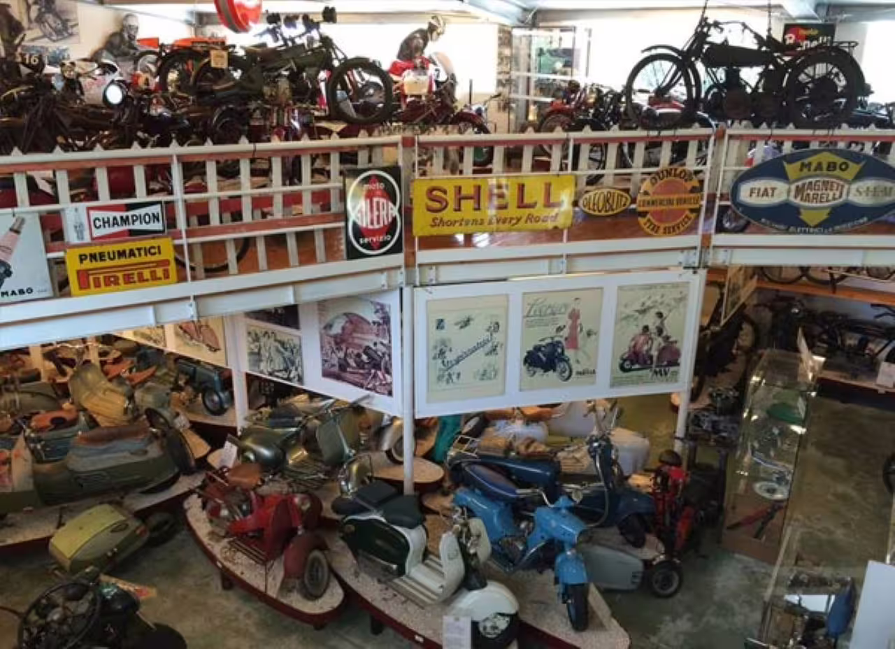 Rimini National Motorcycle Museum interior with vintage bikes, scooters and retro Shell and Pirelli signs