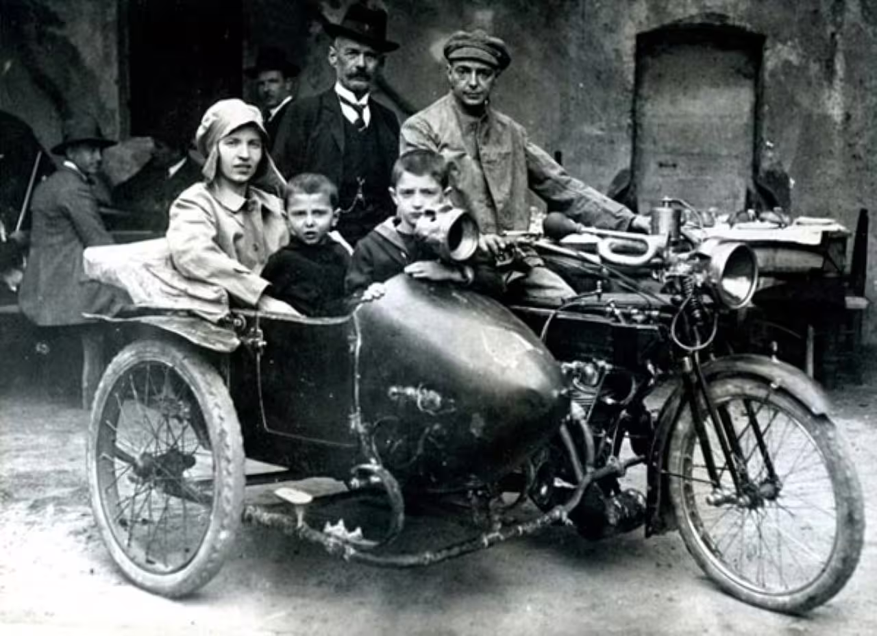 Historic photo of early motorcycle with sidecar, part of Rimini National Motorcycle Museum vintage collection