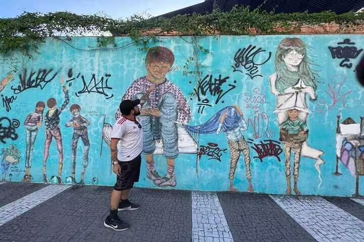 Colorful graffiti wall in Rio with diverse characters and vibrant street art, ideal for urban art enthusiasts.