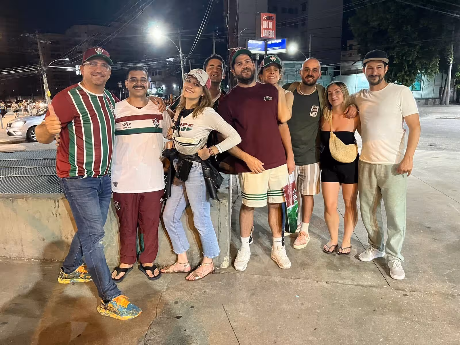 Travelers and locals posing after Rio de Janeiro futbol match near Maracanã, authentic fan experience