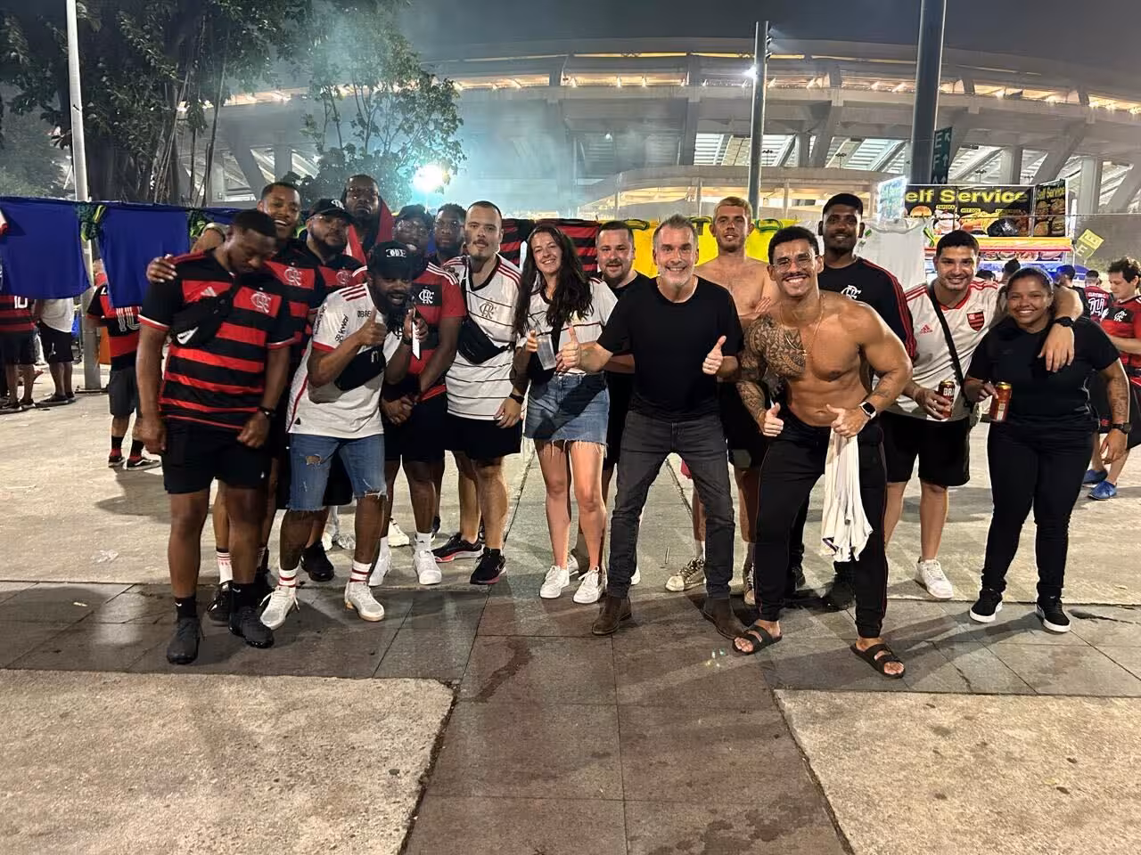 Group photo with locals outside Maracanã Stadium at night, Rio de Janeiro futbol game experience tour
