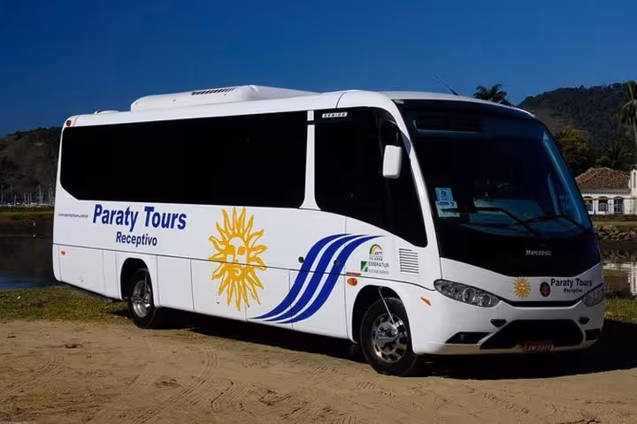 Paraty Tours shuttle bus parked in a picturesque setting, offering reliable service from Rio de Janeiro to Paraty.