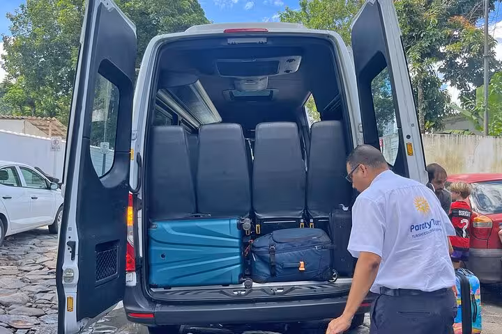 Luggage being loaded into a Paraty Tours shuttle for a scenic transfer from Rio de Janeiro to Ilha Grande.