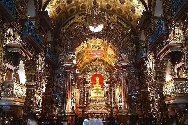 Ornate interior of a historic church in Rio's downtown, featuring intricate gold details and grand architecture.