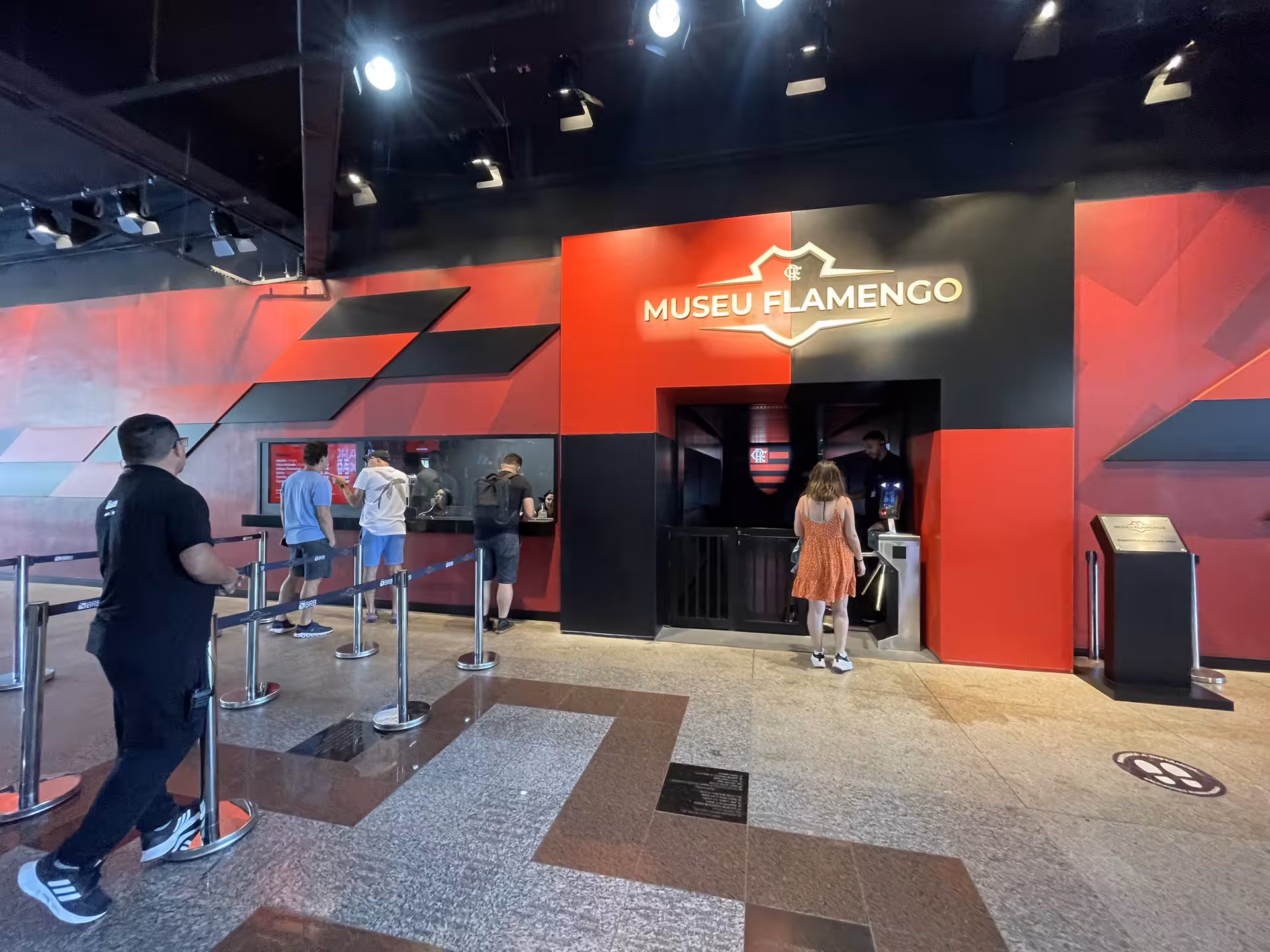 Visitors at the entrance of Museu Flamengo, highlighting the vibrant atmosphere of Rio's football heritage.