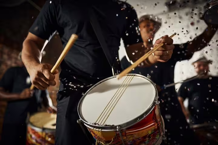 Energetic drummers in Rio performing samba rhythms surrounded by lively confetti for a nightlife tour.