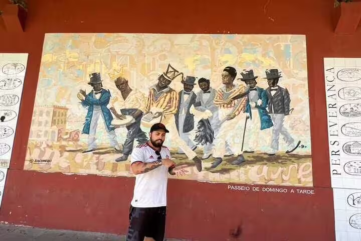 Colorful street mural of dancing figures in Rio, capturing cultural expression on the Graffiti Tour.