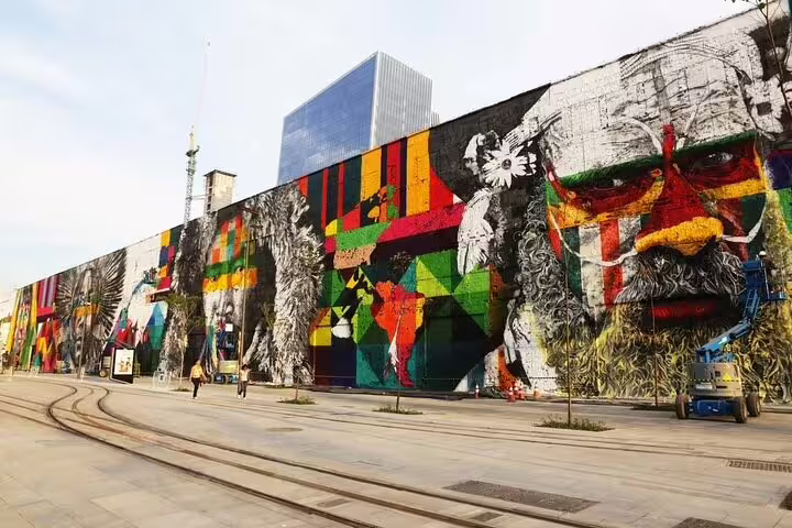 Massive vibrant mural in Rio featuring multicultural themes and geometric patterns, perfect for graffiti tour lovers.