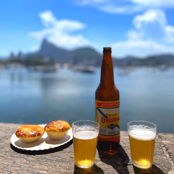 Enjoying cold beer and pastries by Rio's waterfront, with stunning views of Sugarloaf Mountain.