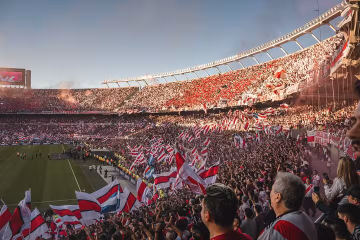 River Plate supporters waving red and white flags at El Monumental, Buenos Aires matchday with local