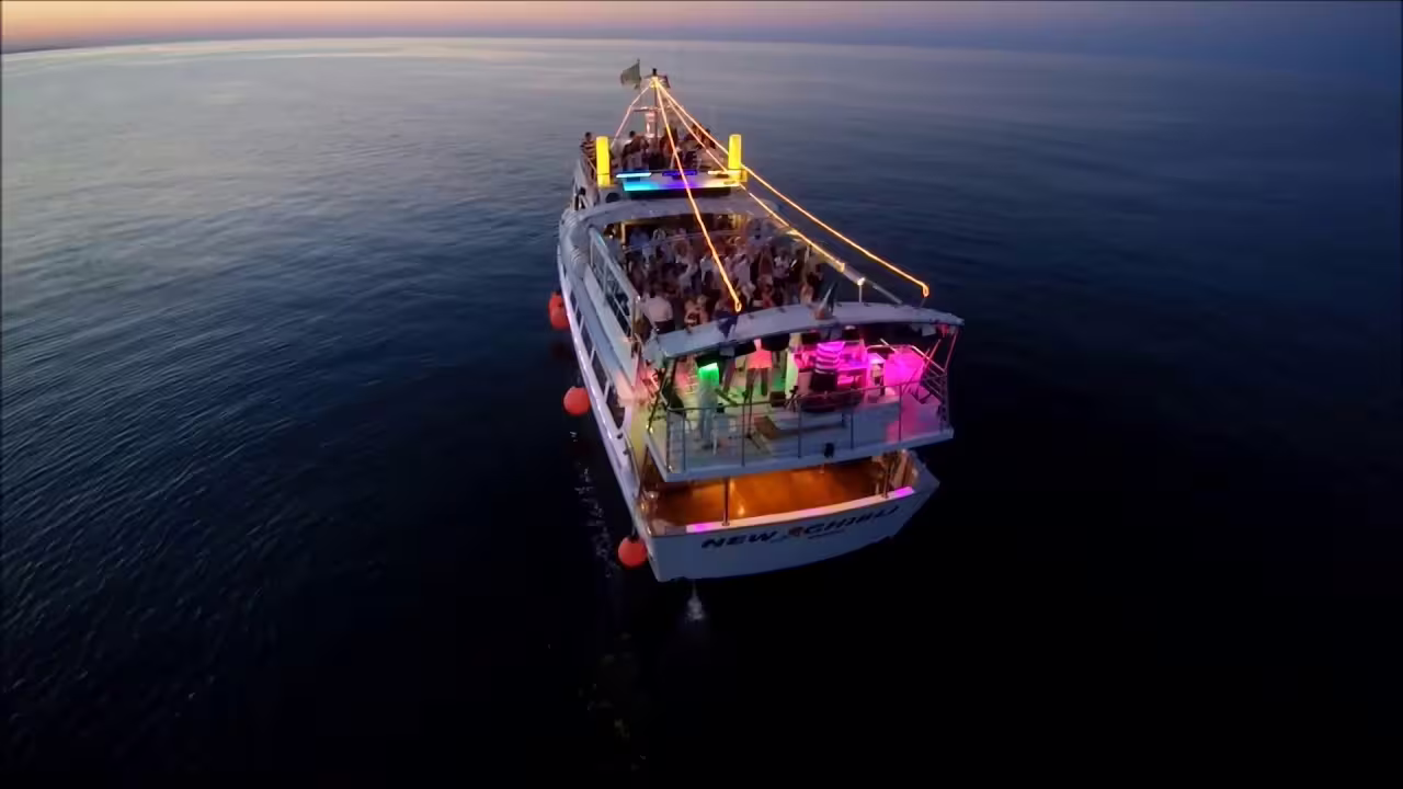 Aerial view of New Ghibli at dusk with party lights, Riviera Romagnola half-day boat tour on the Adriatic