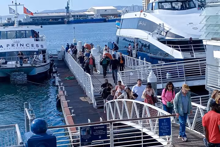 Visitors boarding a ferry to Robben Island from Cape Town, a popular part of South African heritage tours.